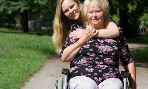 Young woman with older lady using wheelchair