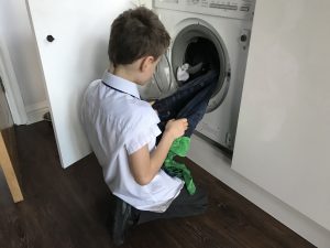 young-boy-loading-washing-machine