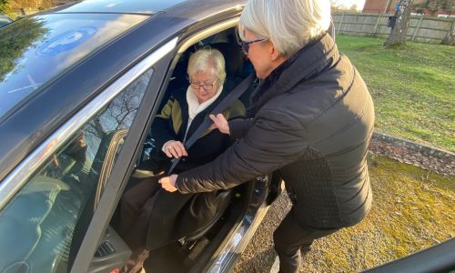 Surrey Carer assisting man out of car